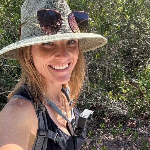 Brit wearing a sun hat and chest-mounted camera on Rusty Lyonia Trail